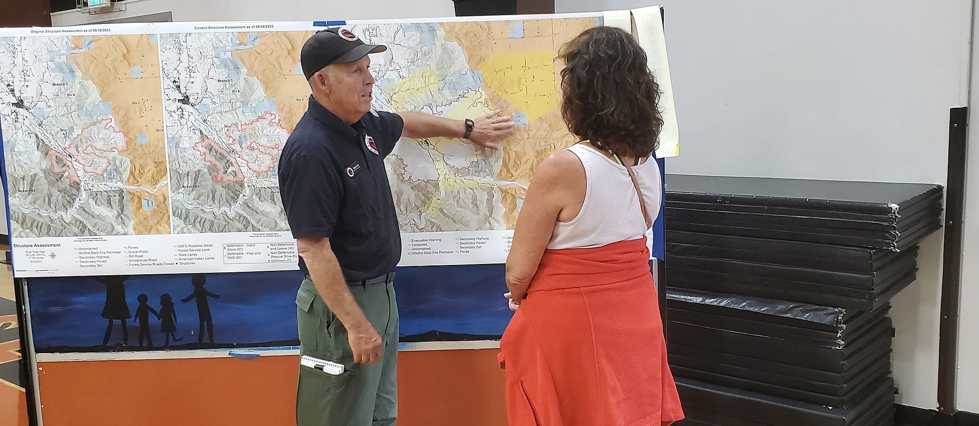 A forester walking a landowner through a map of her property